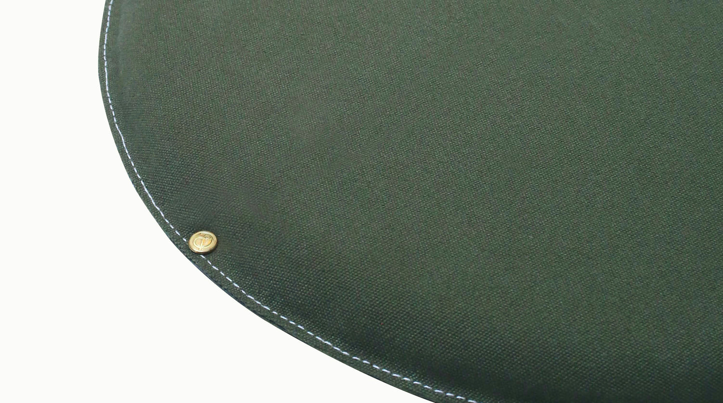 Round water-resistant canvas seat cushion in Oliva Skin with Candyfloss stitching