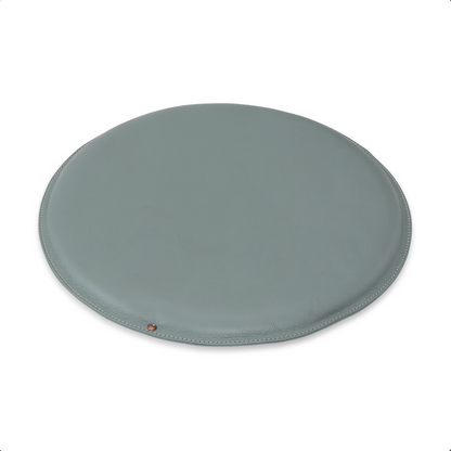 Round leather seat cushion in Misty Green with Pale Pineapple stitching